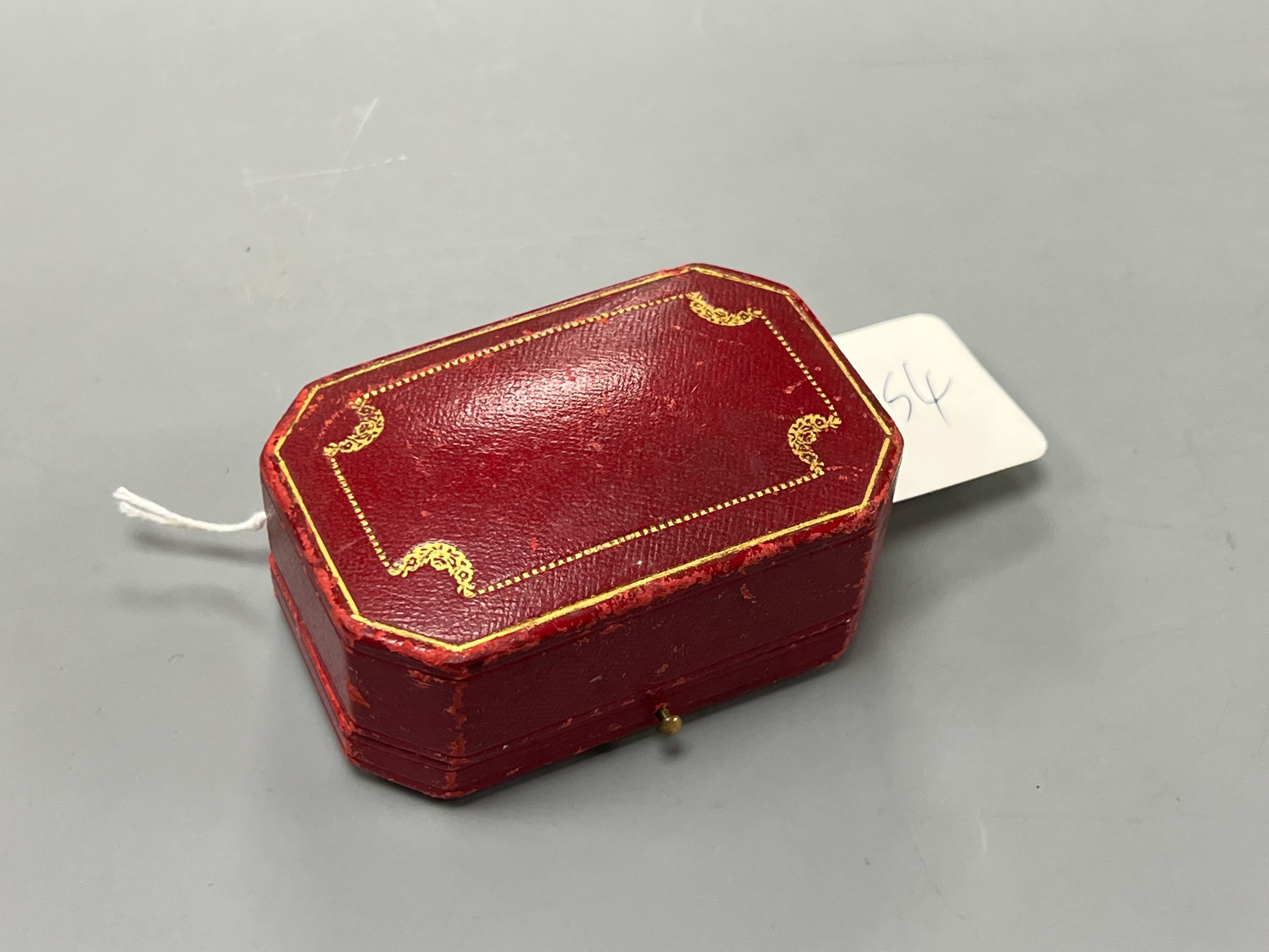 A modern pair of gilt metal earrings, together with a Cartier gilt tooled red leather jewellery box.